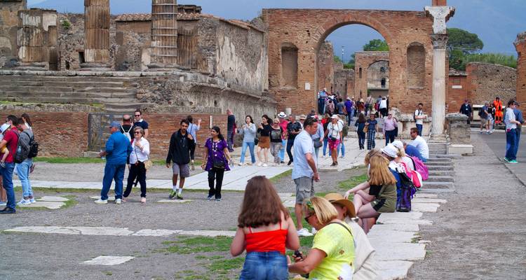 Crowd of tourists exploring the ancient ruins of Pompeii.