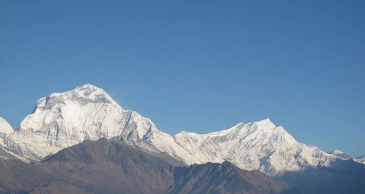 Snow-covered peaks with a clear blue sky.