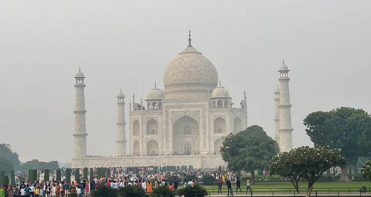 Front view of Taj Mahal with tourists in front.