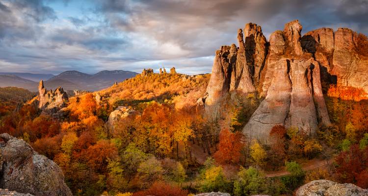 Belogradchik rock formations glowing under a dramatic sky.