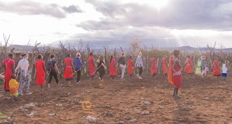 Group of people participating in a cultural dance outdoors