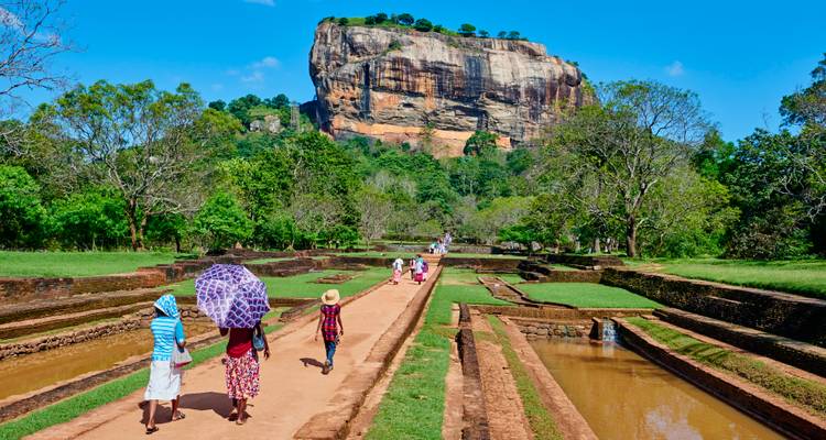 People walking towards the iconic Sigiriya Rock.