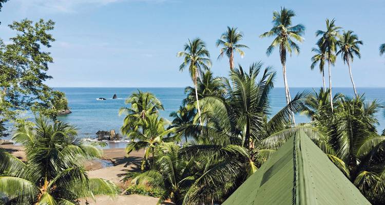 Beach view from a rooftop with blue ocean horizon.