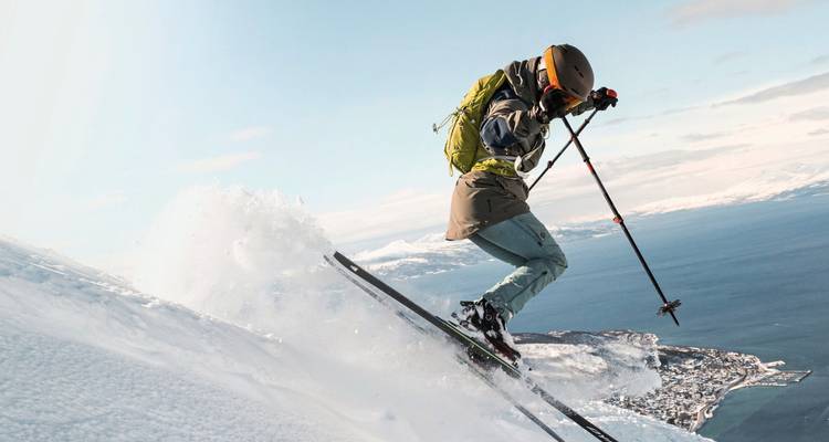 Skieur en action sur un flanc de montagne enneigé.