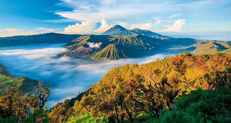 Scenic view of Mount Bromo with clouds and blue sky.