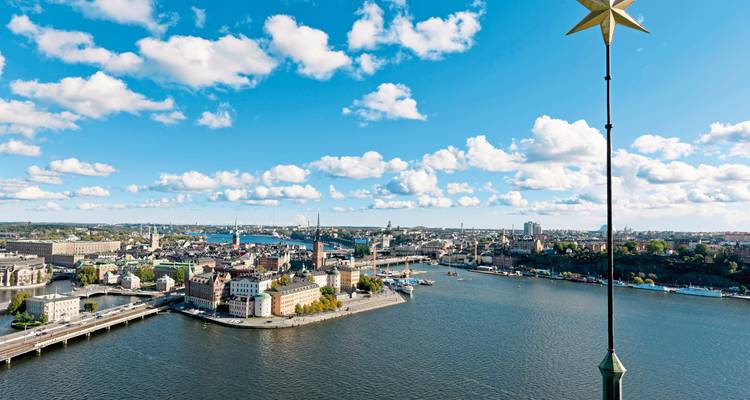 Aerial view of a city with water and a star in the foreground.