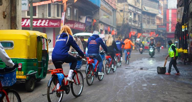 A group of cyclists riding through a busy street.