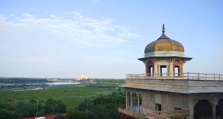 A historic dome overlooking a scenic view of a distant city.