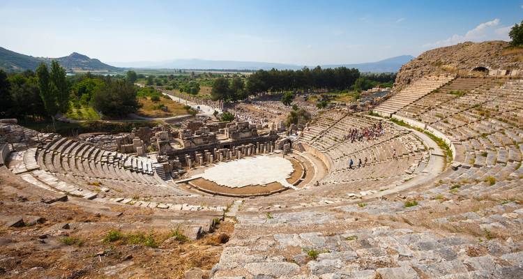 An ancient amphitheater overlooking a scenic view.