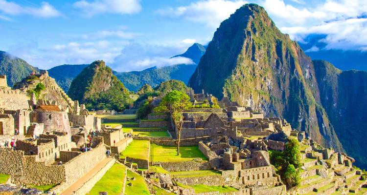 The iconic Machu Picchu with clear skies and vibrant greenery.