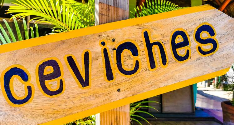 Wooden sign with 'ceviches' written on it.