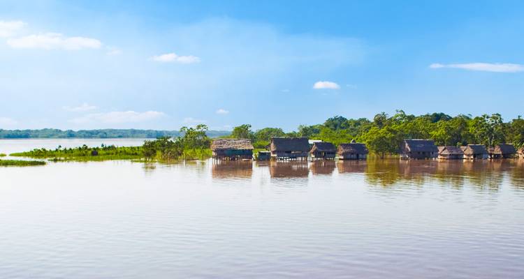 River scene with traditional houses on stilts.