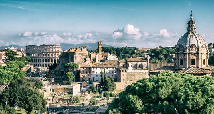 Panoramic view of Rome with the Colosseum and trees.