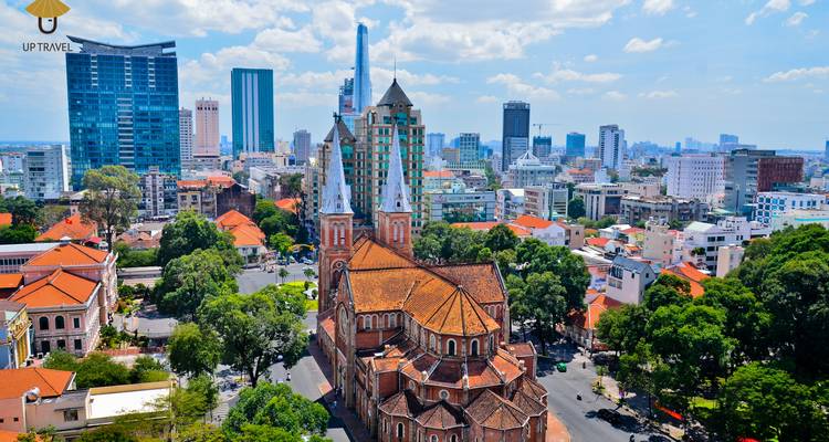 Aerial view of Ho Chi Minh City skyline with a large church and skyscrapers.