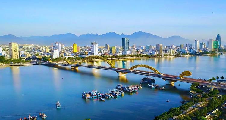 Panoramic view of a city with a bridge over water.