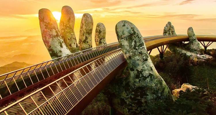 Unique bridge with giant stone hands at sunrise.