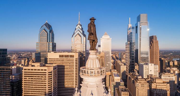 City skyline with a statue and skyscrapers.