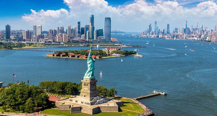 Statue of Liberty with New York City skyline in the background.