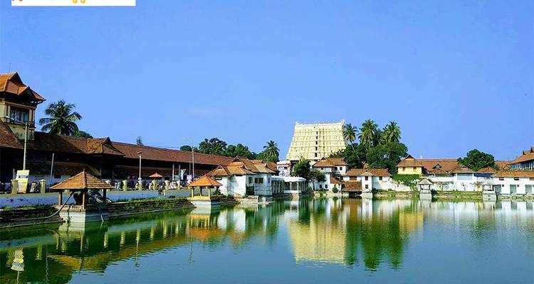 Temple complex by a water tank surrounded by coconut palms.