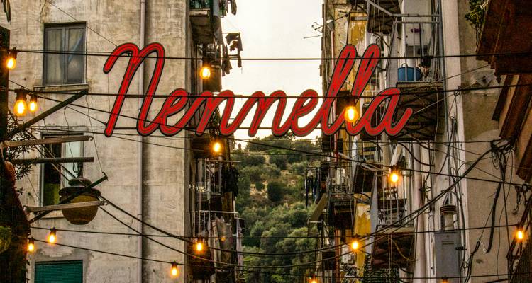 Nennella sign against a backdrop of narrow street with buildings.