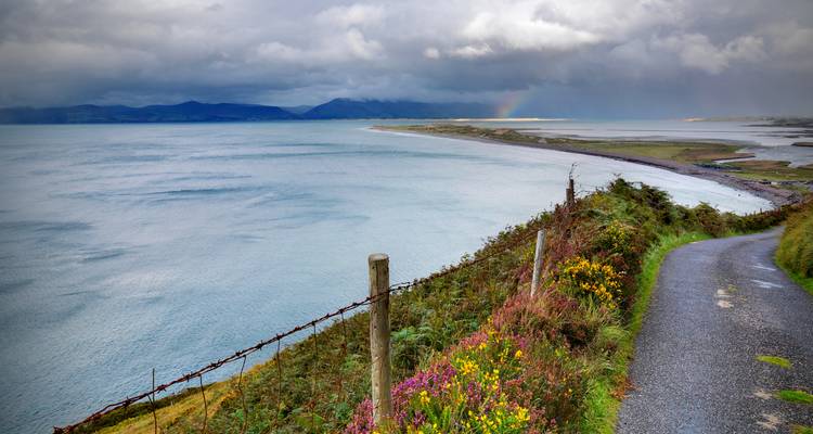 Scenic view of a coastal path with mountains in the distance.