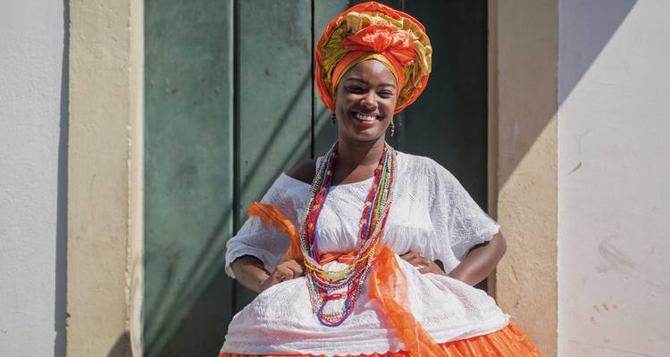 A person in traditional Brazilian attire with vibrant colors.