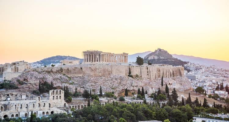 L'Acropole au coucher du soleil avec le Parthénon et d'autres structures antiques.
