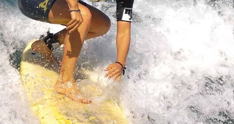 Surfer riding a wave with a surfboard.