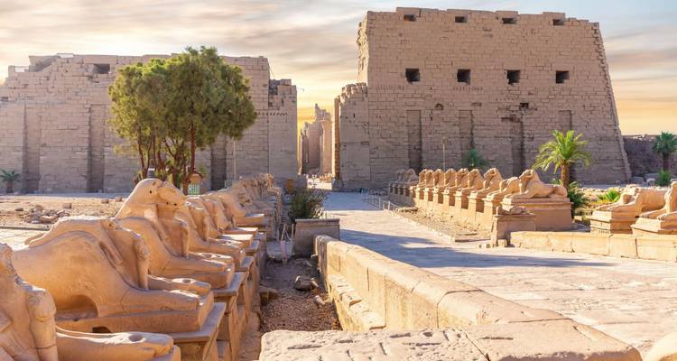 Karnak Temple complex with rows of statues and large structures.