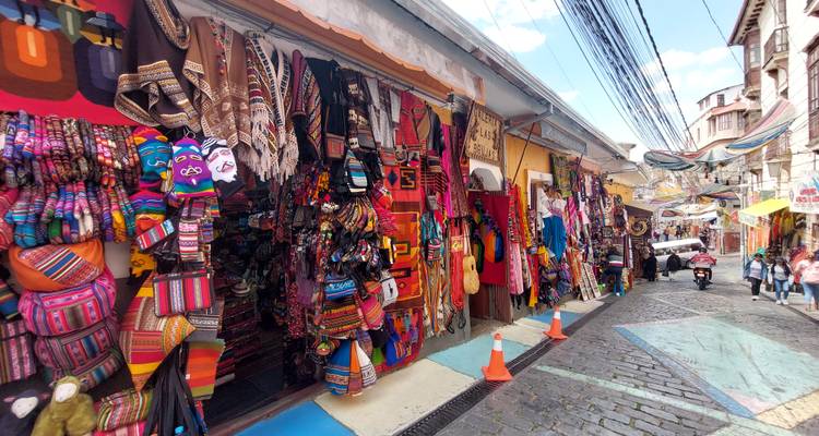 Street market with colorful textiles and handicrafts.