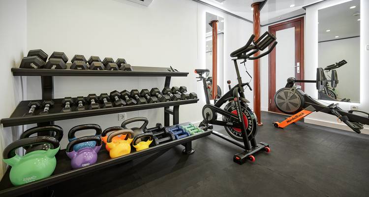 Gym room with weights and exercise equipment on a ship.