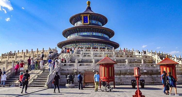 Temple of Heaven with tourists walking around.