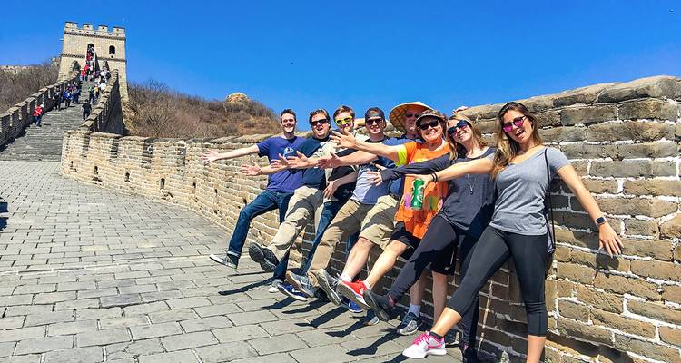 Group of tourists posing on the Great Wall of China.