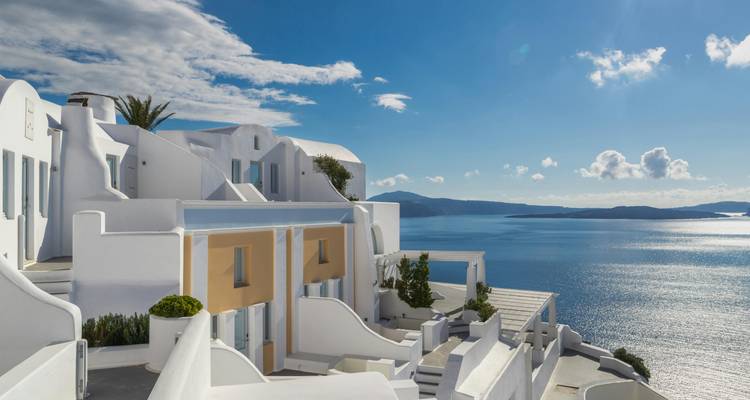 Whitewashed buildings of Santorini overlooking the sea.