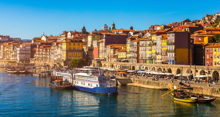 Colorful riverside buildings with boats on the water.