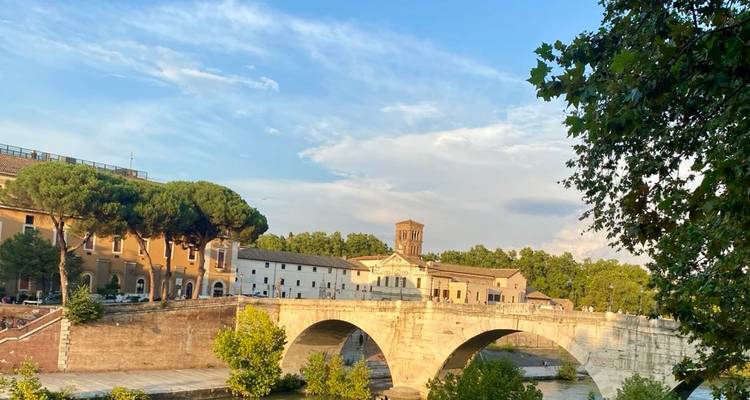 Scenic view of a historic bridge and buildings along a river.