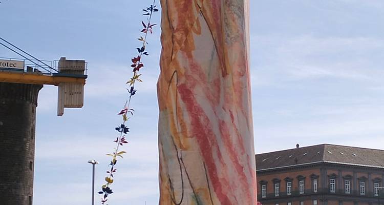 Une œuvre d'art drapée sur une structure dans un environnement urbain.