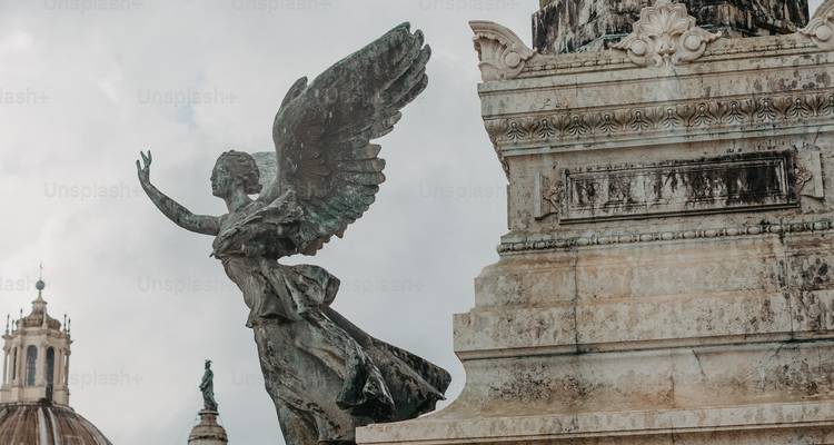 Statue with wings and partial city view, covered in watermarks.