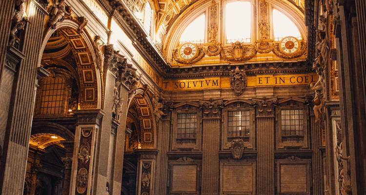 Ornate interior of St. Peter's Basilica with warm lighting.