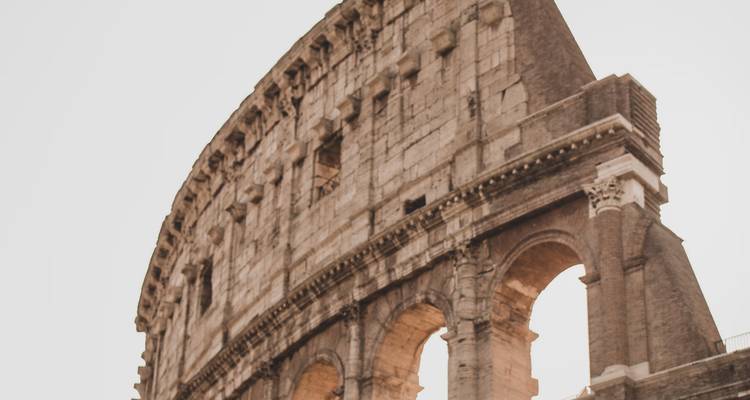 Colosseum viewed from an upward angle with soft lighting.