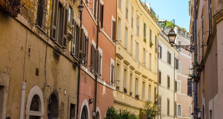 Colorful buildings along a narrow street with shadows.