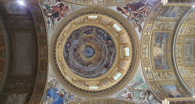 Circular frescoed dome with religious imagery inside a church.