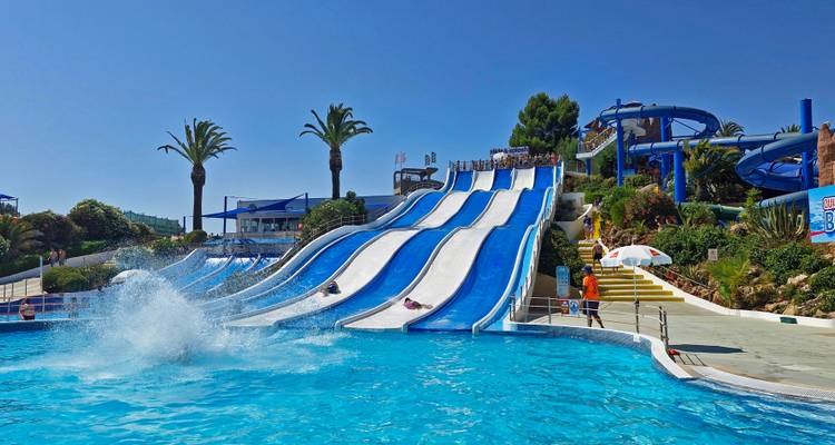 Water park with large slides and a splash pool.