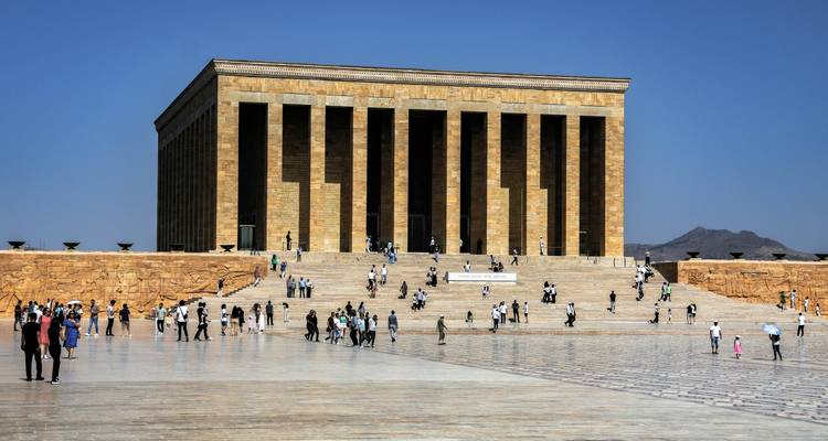 Large historic building with steps and visitors.