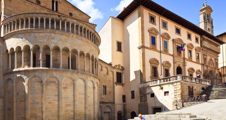 Historic buildings with stone facades and a wide staircase.