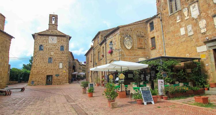 Rustic cafe and square with historical buildings.