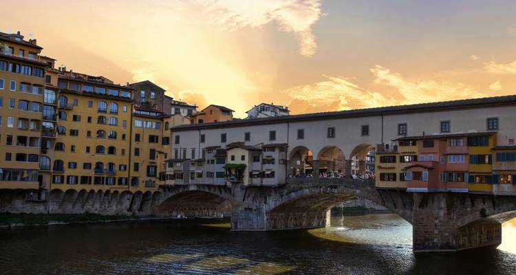 Ponte Vecchio at sunset with a vibrant sky