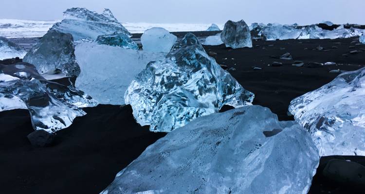 Icebergs on a black sand beach.