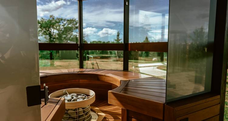Interior view of a modern sauna with glass walls.