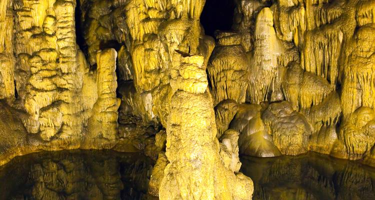 Interior of a cave with stalactites and stalagmites.